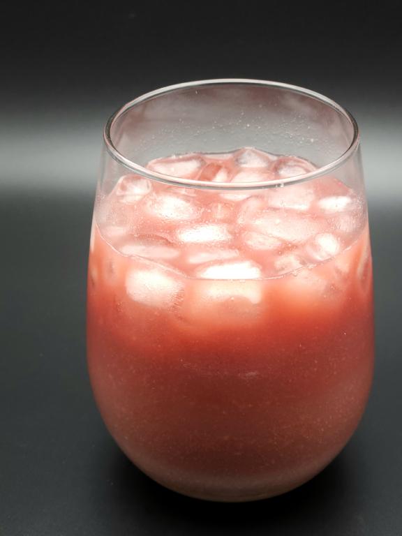 stemless wine glass filled with ice and a murky red liquid