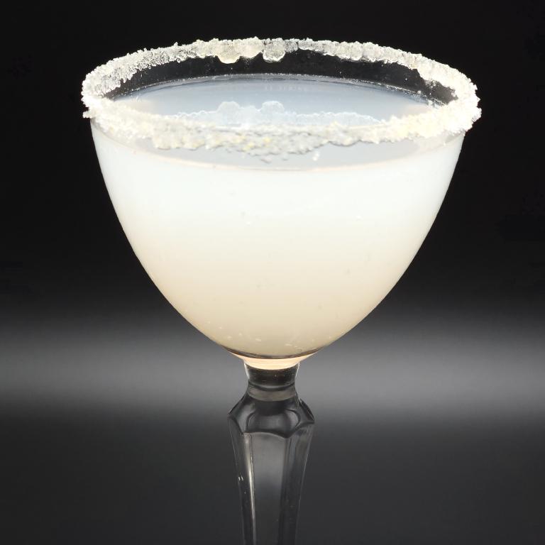 small coupe filled with opaque white liquid and rimmed with a crystalline substance